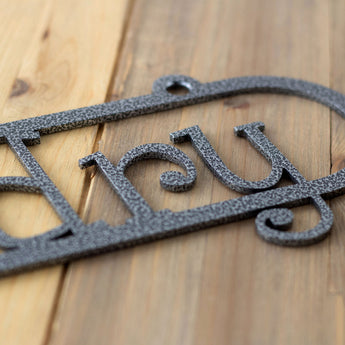 Close up of silver vein powder coat on our metal child name sign. 