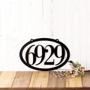 4 Digit oval metal house number sign with 2 mounting holes, in matte black powder coat. 
