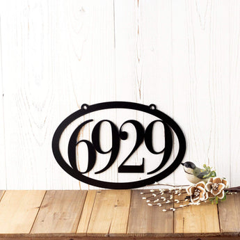 Horizontal oval 4 digit metal house number sign, in matte black powder coat. 