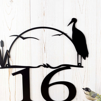 Close up of heron & cattails with a lake sunset on our 2 digit metal house number sign, in matte black powder coat.