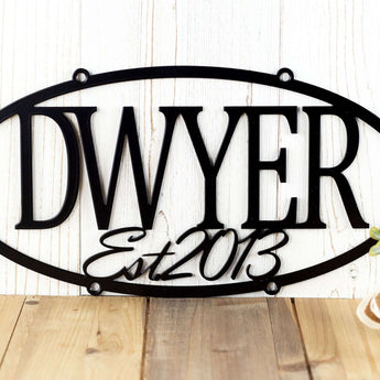 Close up of established year on our oval custom family name sign, in matte black powder coat. 