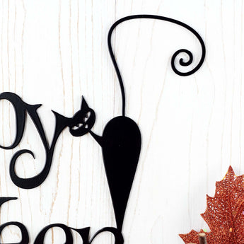 Close up of black cat on the Happy Halloween metal wall art.