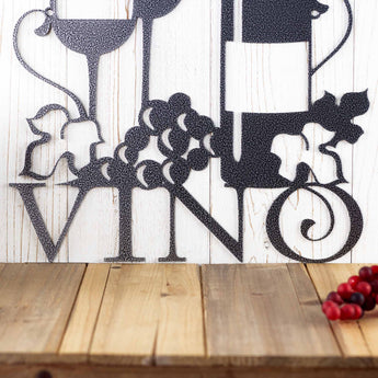 Close up of Vino word on our Vino metal wall art with grapes, in silver vein powder coat. 