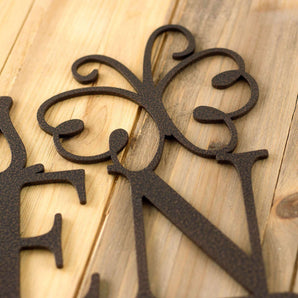 Close up of copper vein powder coat on our metal garden name sign with a butterfly.