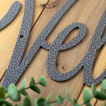 Close up of silver vein powder coat on the Velkommen sign. 