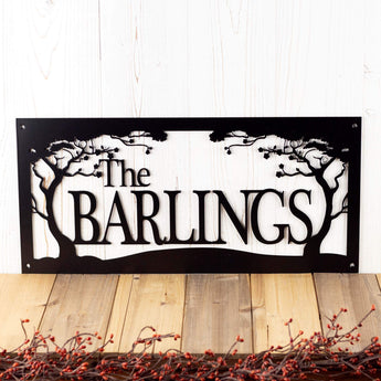 Rectangular metal family name plaque with cherry trees, in matte black powder coat. 