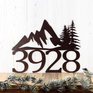 4 digit metal house number sign with mountains and pine trees, in copper vein powder coat. 