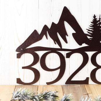 Close up of mountains on our 4 digit metal house number sign, in copper vein powder coat.
