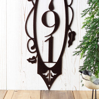 Close up of 3 digit vertical house number plaque, in copper vein powder coat.