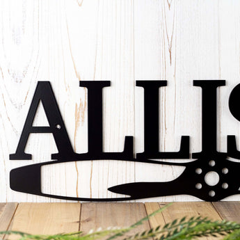 Close up of family name on our aviator pilot propeller sign, in matte black powder coat.
