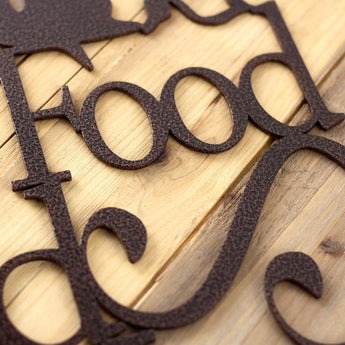 Close up of copper vein powder coat on our Good Food Good Wine Good Friends metal plaque. 