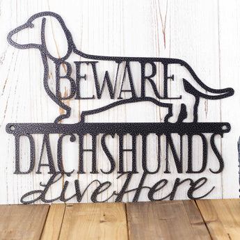 Close up of Dachshunds Live Here wording on our Dachshund metal sign, in silver vein powder coat.