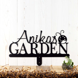 Metal garden sign with first name and ladybug image, in matte black powder coat. 