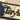 Close up of matte black powder coat on the rectangular metal family name sign.