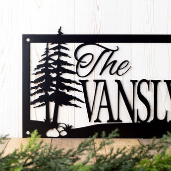 Close up of pine trees on our personalized family name sign, in matte black powder coat. 