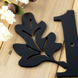 Close up of matte black powder coat on our 2 digit oak leaves metal house number sign.