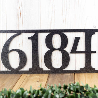 Close up of 4 digit rectangular metal house number sign, in silver vein powder coat. 