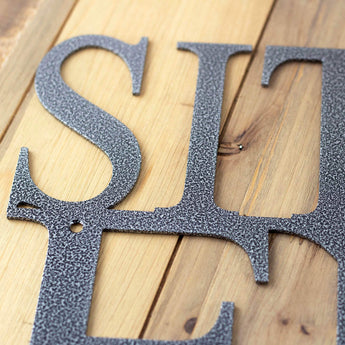 Close up of silver vein powder coat, on our Sit Relax Enjoy sign.