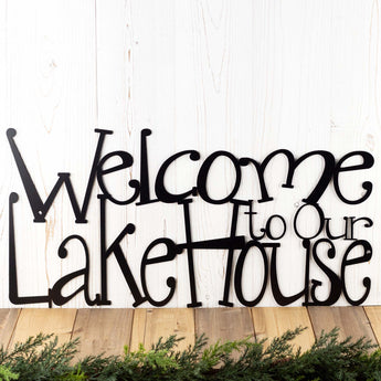 Close up of Welcome to Our Lake House metal wall art, in matte black powder coat.