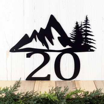Close up of mountains and pine trees on our 2 digit metal house number plaque.