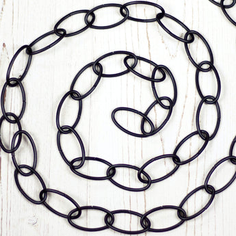 Black metal chain positioned in a spiral.