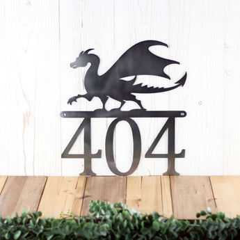 3 digit metal house number sign with a dragon silhouette, in raw steel. 