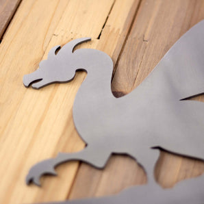 Close up of raw steel on our dragon metal house number sign.