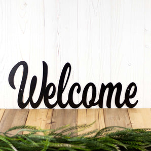 Welcome metal sign with script lettering, in matte black powder coat. 