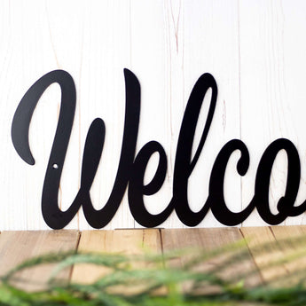 Close up of script lettering on our welcome metal sign, in matte black powder coat. 