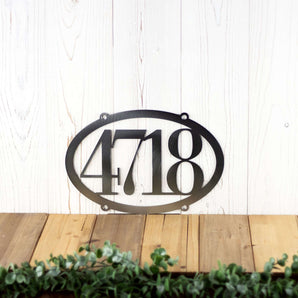 Horizontal oval 4 digit metal house number sign, in raw steel.