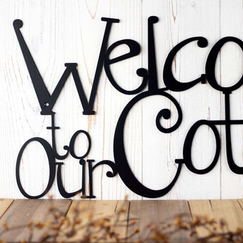 Close up of words on our Welcome to our cottage metal wall decor, in matte black powder coat. 