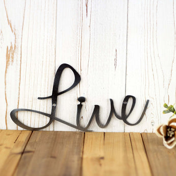Close up of Live script word sign of our Live Laugh Love metal wall art, in raw steel.