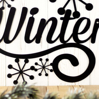 Close up of snowflakes on our Winter sign, in matte black powder coat. 