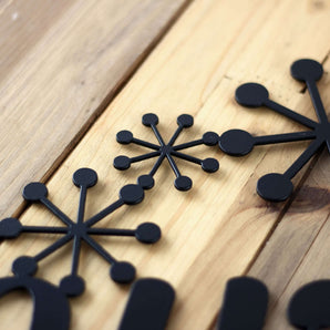 Close up of matte black powder coat, on our  Winter metal wall art.