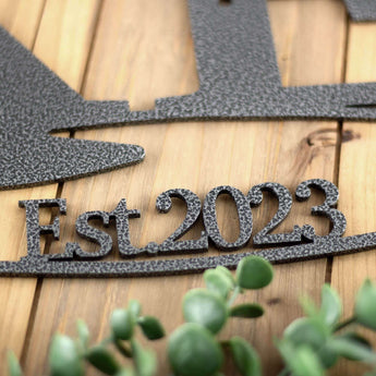 Close up of silver vein powder coat on our propeller metal sign with established year. 