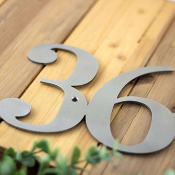 Close up of raw steel on our metal house number sign. 