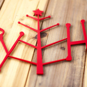 Close up of red gloss powder coat on our Happy Holidays metal wall art. 