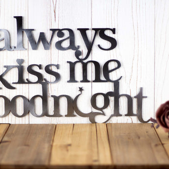 Close up of lettering on our Always Kiss Me Goodnight metal sign, in raw steel.
