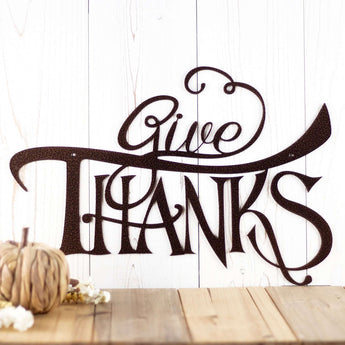 Give Thanks metal wall art with script lettering, in copper vein powder coat. 