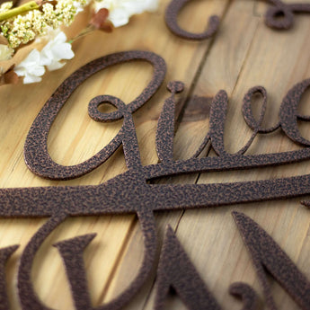 Close up of copper vein powder coat on our Give Thanks metal wall art.