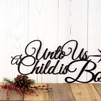 Close up of Unto Us A Child Is Born metal sign, in matte black powder coat.