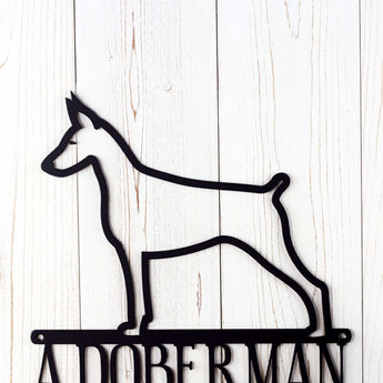 Close up of Doberman dog silhouette on our Doberman Lives Here metal wall decor, in matte black powder coat. 
