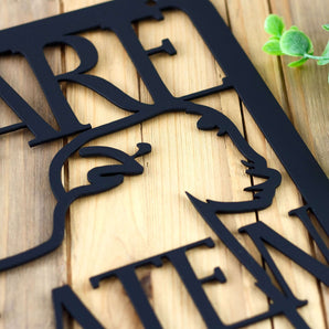 Close up of matte black powder coat on our Beware Wheaten Greetin ahead metal sign.