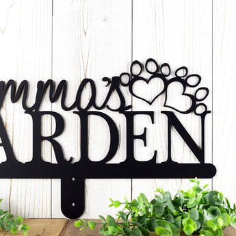 Custom garden name sign with dog name and dog paws, in matte black powder coat.