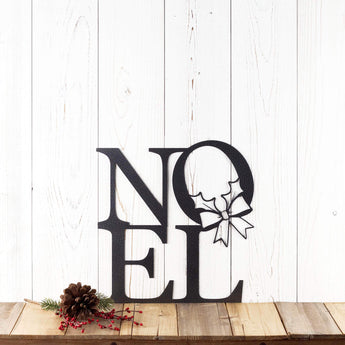 Noel metal wall art with Christmas wreath, in silver vein powder coat. 