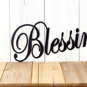 Close up of script lettering on our Blessings metal wall art, in matte black powder coat.