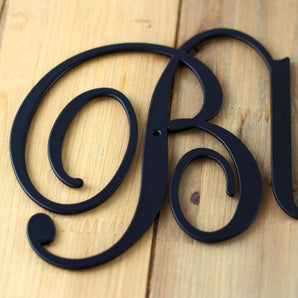 Close up of matte black powder coat on our Blessings script metal wall art. 