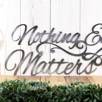 Close up of Nothing Else Matters metal sign, in raw steel.