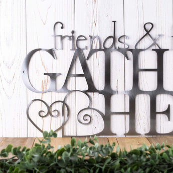 Close up of Friends lettering on our Friends & Family Gather Here metal sign, in raw steel. 
