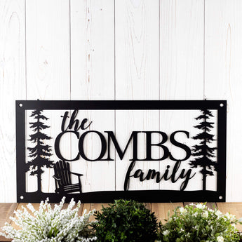 Rectangular personalized family name metal sign with adirondack chair and cedar trees, in matte black powder coat.